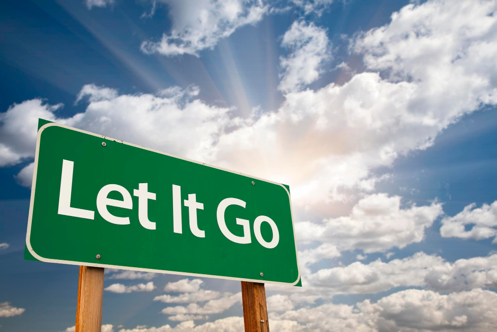let it go road sign with a mostly sunny sky behind it let it go road sign