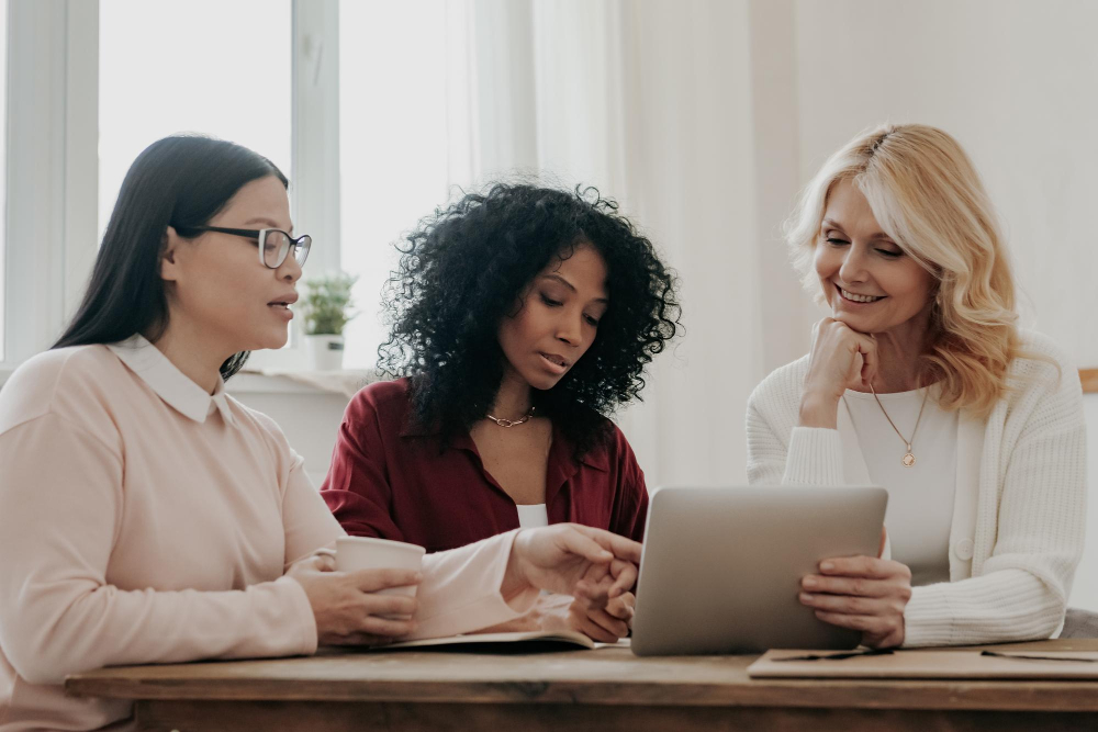 three business women studying reports three business women studying reports