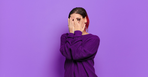 woman covering face with hands woman covering face with hands