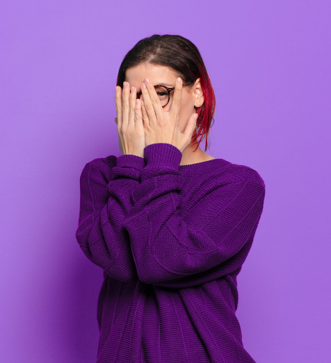 photo of a woman covering her face with her hands, peeking out